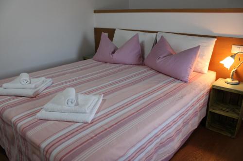 a bedroom with a bed with towels on it at Giuliva B&B in Refrontolo