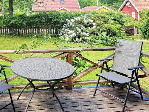 two chairs and a table on a wooden deck at 3 person holiday home in VÄSTERVIK-By Traum in Västervik