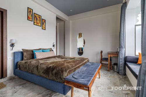 a bedroom with a bed and a couch at Footprint By The Lake in Udaipur