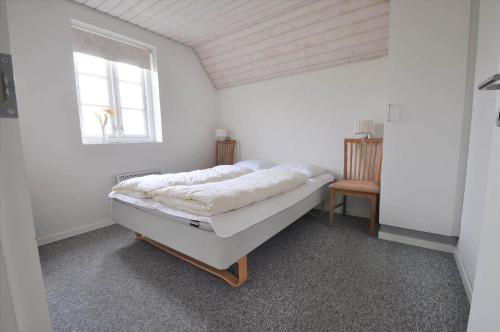 a bed in a room with a window at 10849-Ulfborg-Dommersovej-17 in Øby