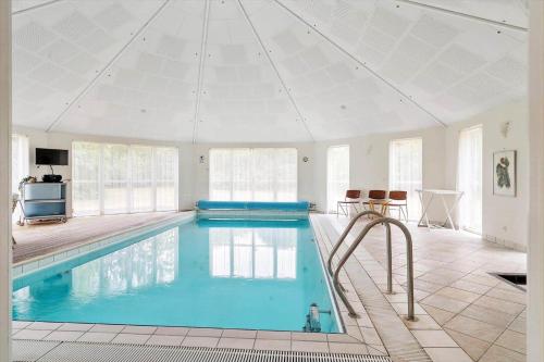 a large swimming pool in a house with a ceiling at 80608-Vemb-Knudehus-51 in Lillelund