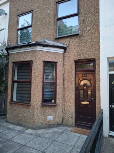 un edificio de ladrillo con una puerta y ventanas marrones en Peacock Quarters, en Croydon