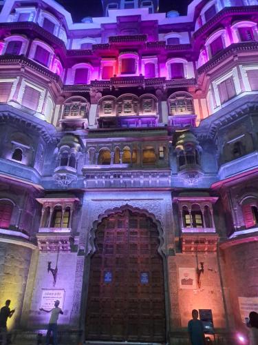 a building with purple lights on top of it at Narmada Guest House in Indore