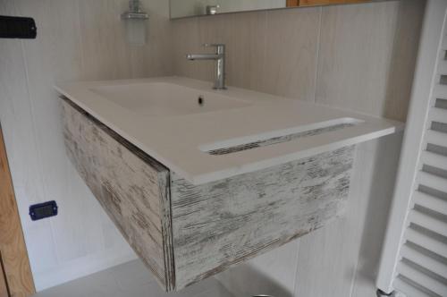 a bathroom with a white sink and a mirror at Casa Rosanna in Meolo