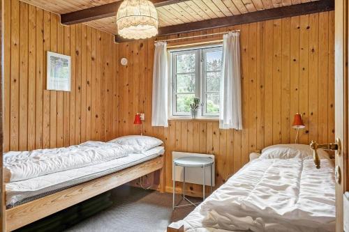 a bedroom with two beds and a window at 10288-Ulfborg-Svollingvej-13 in Øhuse