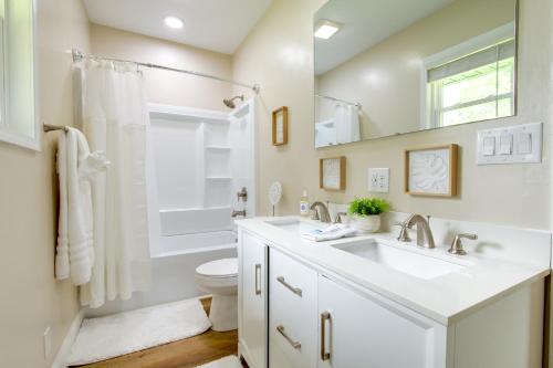 a white bathroom with a sink and a toilet at Dog-Friendly Jackson Home Near Downtown Hub! in Jackson