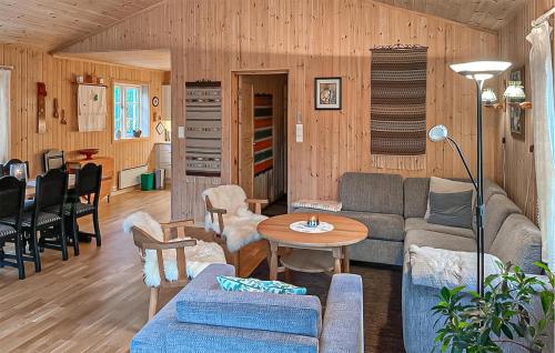 a living room with a couch and a table at 4 Bedroom Cozy Home In Straumgjerde in Brunstad