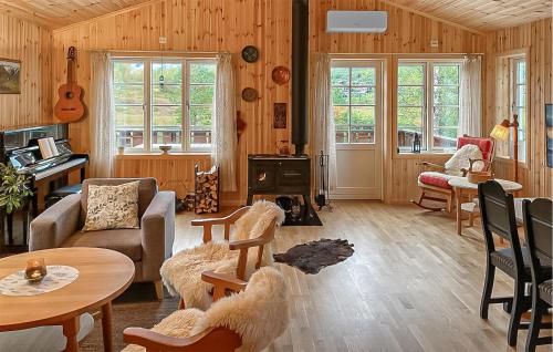 a living room with wood paneled walls and a stove at 4 Bedroom Cozy Home In Straumgjerde in Brunstad