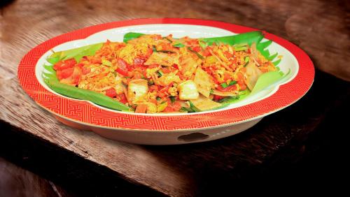 a plate of food on a wooden table at Crowne Plaza Kunming City Centre by IHG in Kunming