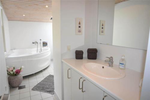 a white bathroom with a sink and a tub at 30826-Ulfborg-Klovervej-480 in Vang