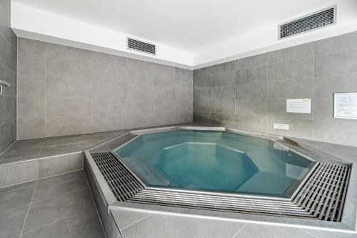 a large blue bath tub in a bathroom at Wellness apartmán Pila Kvilda in Kvilda
