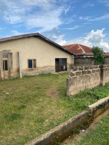 an old building with a grass yard in front of it at Mansion in Akure