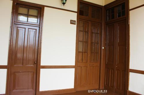 a pair of wooden doors in a room at Villa La Punta in Lima