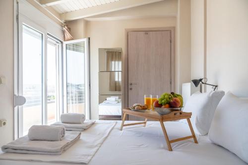 a bedroom with a table with fruit on it at Eagles Nest Panoramic SeaView Apartment in Thérissos
