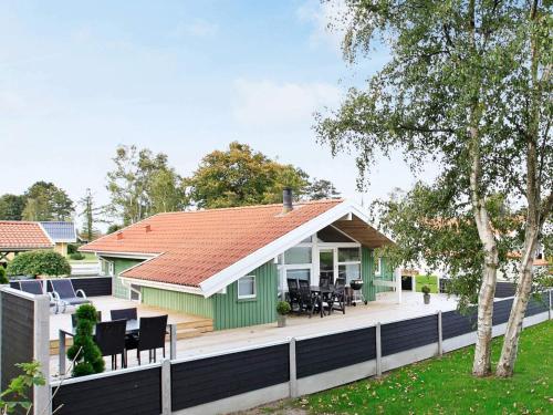 a green house with a red roof at Seaside Bliss with Spa - By Traum Ferienwohnungen in Otterup