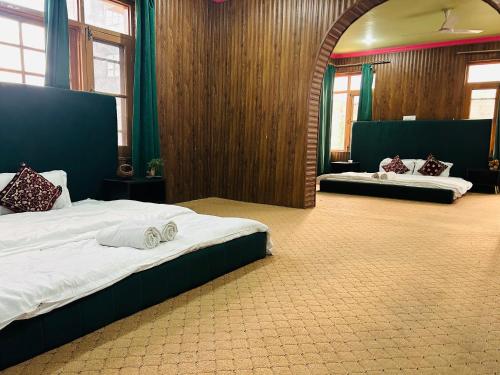 a bedroom with two beds in a room at hotel queen city in Srinagar
