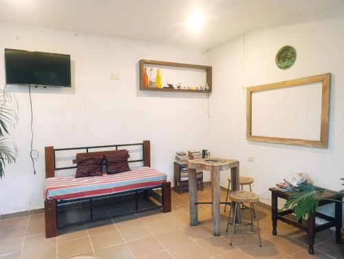 a bedroom with a bed and a table and a mirror at Hermoso Palomino in Palomino