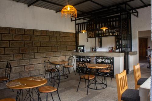 a restaurant with tables and chairs and a bar at Saba House and Lodges in Machakos