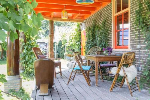 a porch with a wooden table and chairs on it at Reijgershof Art Deco Room with private bathroom in Amsterdam
