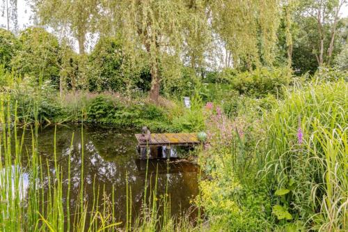 a pond with a bird sitting in the water at Reijgershof Art Deco Room with private bathroom in Amsterdam