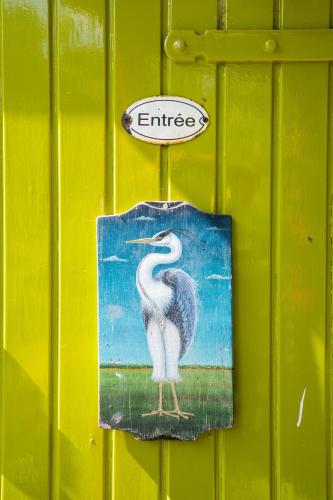 a painting of a pelican on a green wall at Reijgershof Art Deco Room with private bathroom in Amsterdam