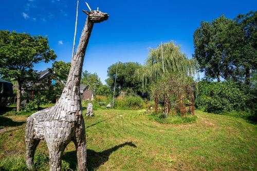 a statue of a giraffe standing in a field at Reijgershof Art Deco Room with private bathroom in Amsterdam