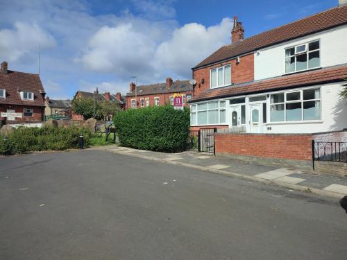 an empty street in a town with brick houses at Luxury ground floor modern flat close to city with free parking in Leeds
