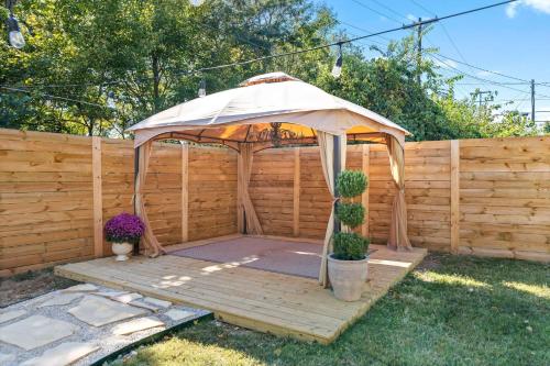 a gazebo with an umbrella in a yard at The Pink and Old Clarksville House - Alpha Link Homes in Clarksville