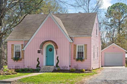 a pink house with a blue door at The Pink and Old Clarksville House - Alpha Link Homes in Clarksville