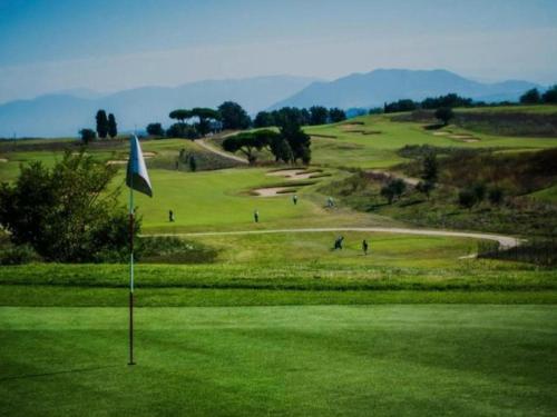 a golf course with a flag on a green at Casa del Lago in Monterosi