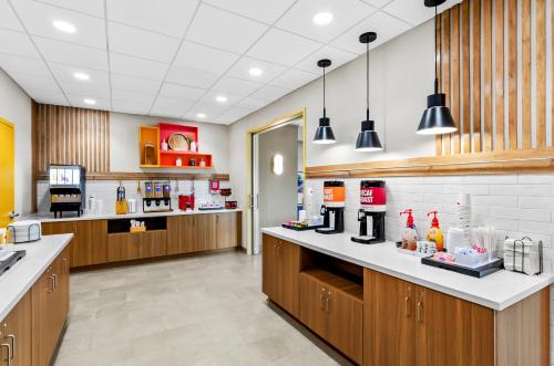 a kitchen with wooden cabinets and a counter top at Hampton Inn Daleville in Daleville