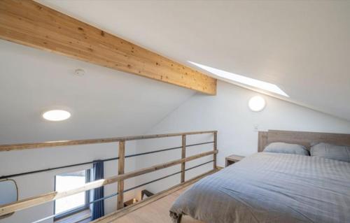 a bedroom with a bed and a large window at Au pied de La Redoute in Sougné-Remouchamps