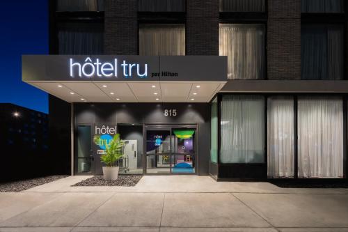 a store front of a building with a hotel trump sign at Tru By Hilton Montréal centre-ville in Montréal