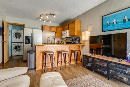 a kitchen with a bar with stools in it at Juneau Apartment - Minutes to Mendenhall Glacier in Juneau