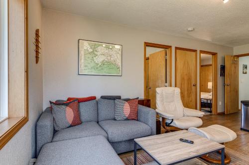a living room with a couch and a table at Juneau Apartment - Minutes to Mendenhall Glacier in Juneau