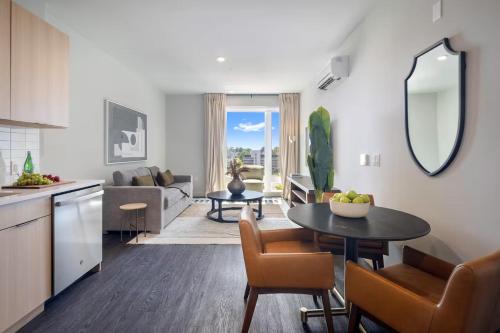 a kitchen and living room with a table and chairs at Luxury Apartments by Hyatus White Plains in White Plains