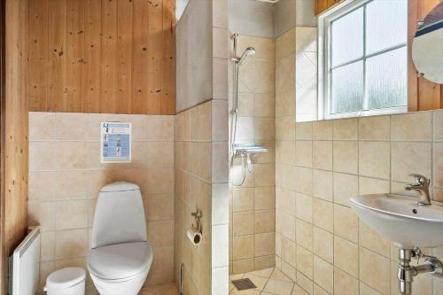 a bathroom with a toilet and a sink at 10787-Ulfborg-Graevlingevej-10 in Øhuse