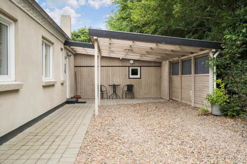a garage with a table and chairs in it at 80057-Ulfborg-Rolighedsvej-3 in Husby