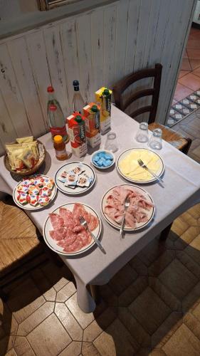 a table with plates of food on it at Le Camere sul Fiume in Boccatossa
