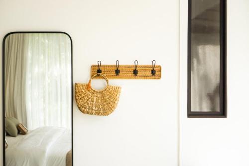 a bedroom with a mirror next to a bed at Naatooh Guest Houses in Florianópolis