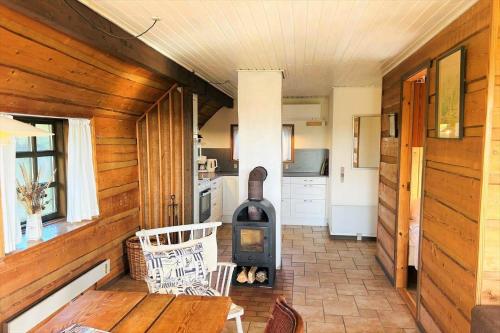 a kitchen with a stove in the middle of a room at 21300-Ulfborg-Somaerkevej-6-b in Vedersø Klit