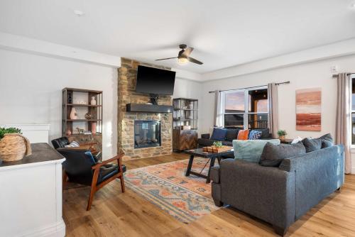 a living room with a couch and a fireplace at Pineapple Shores - Stay for 14 in Hollister