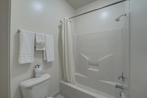 a white bathroom with a shower and a toilet at Casa Rosa Inn in Port Isabel