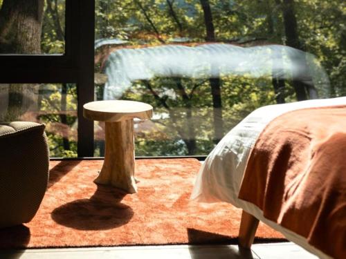 Postel nebo postele na pokoji v ubytování Cabane dans les arbres