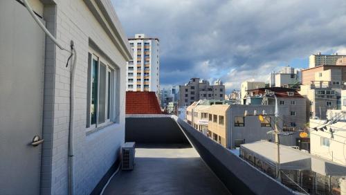a balcony of a building with a view of a city at Busan Jeonpo Station 3min Rooftop Stay in Samgong