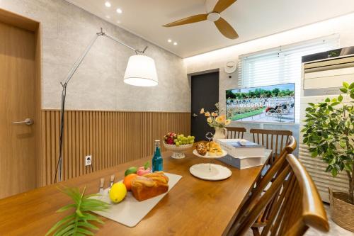 a dining room with a table with fruit on it at Busan Jeonpo Station 3min Rooftop Stay in Samgong