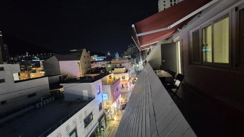 a view of a city at night from a building at Busan Jeonpo Station 3min Rooftop Stay in Samgong