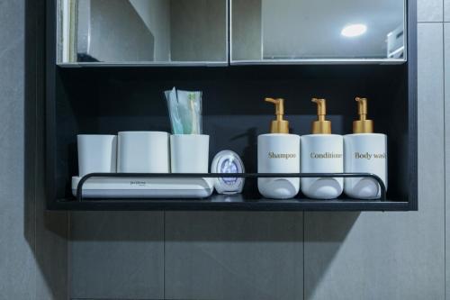 a shelf with a bunch of toiletries on it at Busan Jeonpo Station 3min Rooftop Stay in Samgong