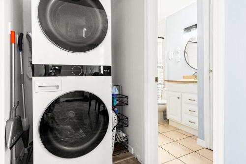 a washer and dryer in a white bathroom with a washing machine at The Villages of Seaport 144 in Cape Canaveral