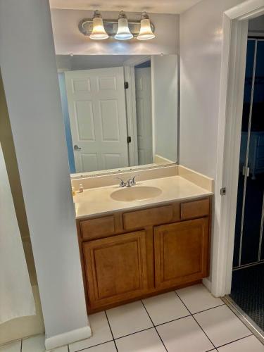 a bathroom with a sink and a mirror at Ocean Walk Resort - Breathtaking Ocean Front View in Daytona Beach